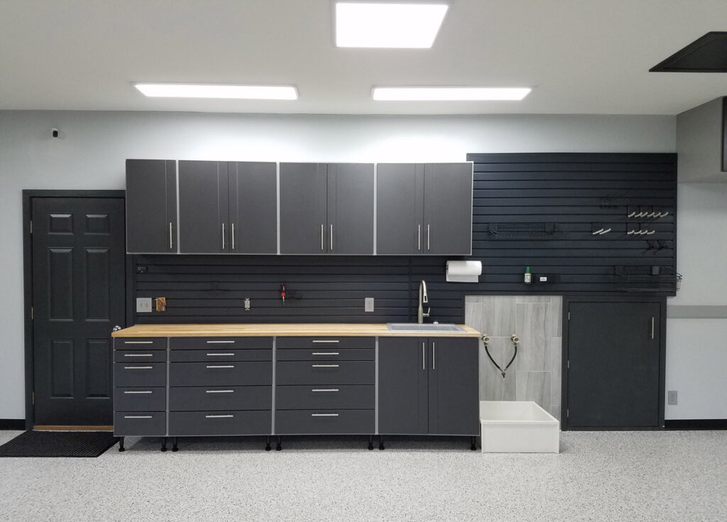 Complete garage storage system with cabinets and shelving